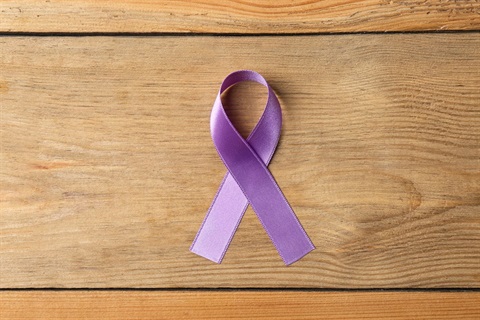 purple-ribbon-on-brown-wooden-background-top-view-2026-03-20-19-08-06-utc.jpg