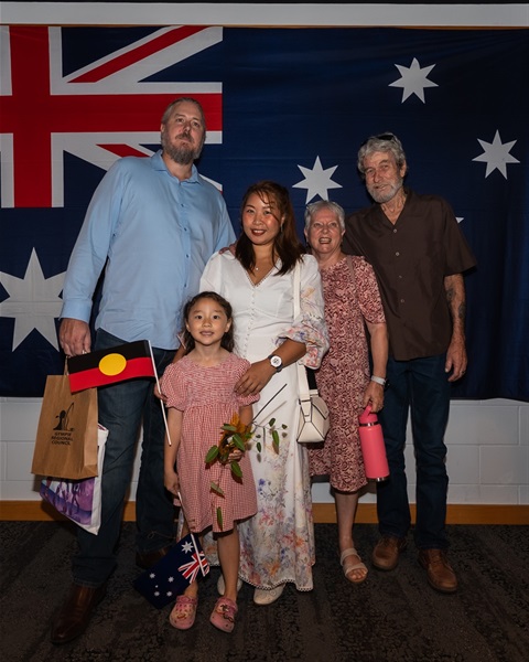 A new citizen celebrates with her family after receiving her citizenship certificate.jpg